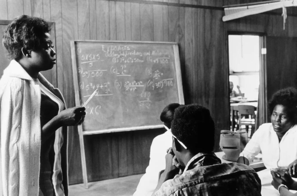 Doris Derby, A Volunteer Mathematics Teacher with Students at Tufts, Mound Bayou, Mississippi 1968. Courtesy of the artist.