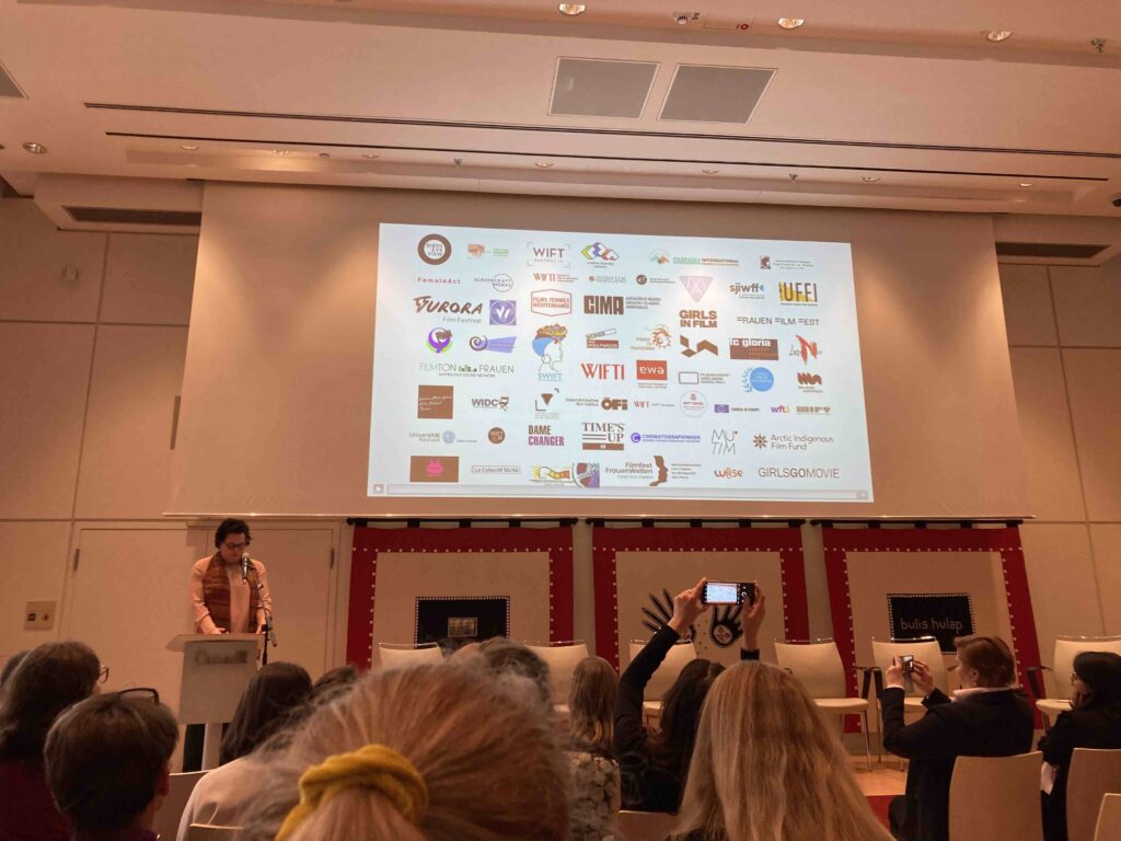 Fig. 2: Barbara Rohm, co-founder of Power to Transform!, welcoming attendees representing women's organisations around the world.
